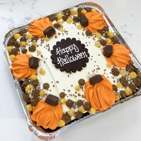 Halloween traybake decorated with pumpkins and a piped message